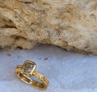 Chael jewelry - custom yellow diamond ring set in gold with limestone in the background
