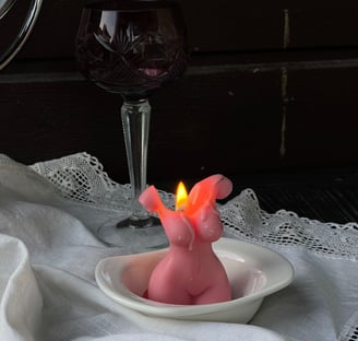a hand made pink candle in a form of  a human body