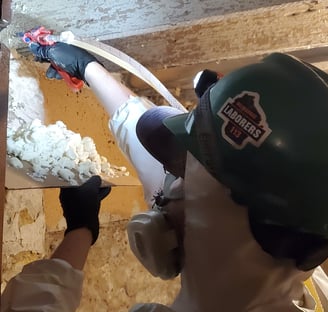 Energy assessor insulates rim joists and sealing gaps to stop energy loss