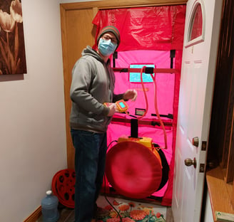 Energy assessor sets up the blower door for a home energy assessment.