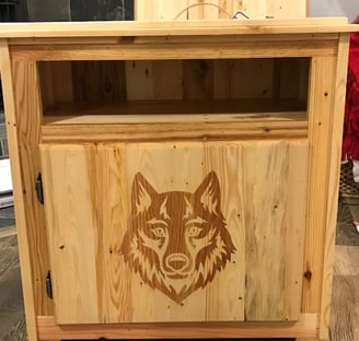 a wooden cabinet with a wolf head on it