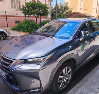a silver car parked on the side of a street