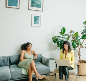 Two women who are seated having a conversation