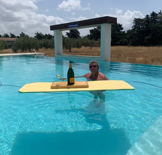 Guest enjoying the infinity swimming pool at Domaine Des Lucques