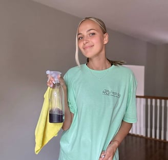 A professional cleaner displays a cleaning product