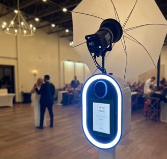 a photobooth camera flasher with a white umbrella and a white umbrella