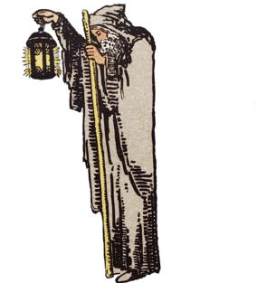 Tarot Hermit male wearing a cloak holding a lanterns and walking stick.