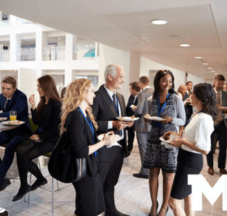 a group of people standing around a table