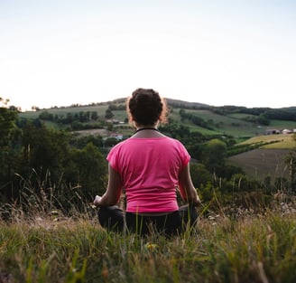 Young woman meditating in the countryside.