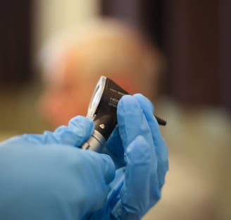 RB Microsuction practitioner using otoscope