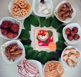 a cake with sri lankan aurudu food on the table
