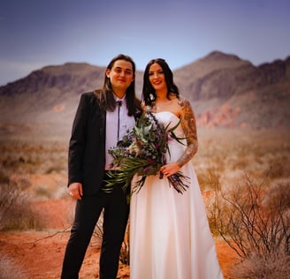 a man and woman standing in the desert