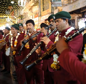 Crew members of the Manohar Brass Band playing clarinet, shehnai, and thap dhol instruments during a traditional performance.