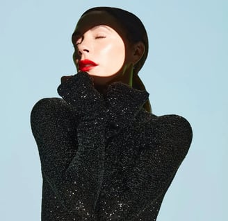 Photo by Allure magazine Victoria Beckham in a stylish black outfit, epitomising fashion and beauty.