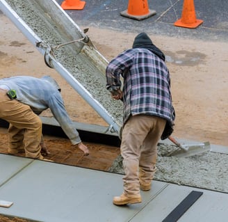 two men working on a concrete slab