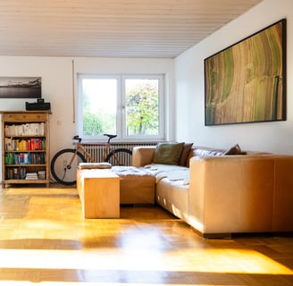 a living room with a couch and a bike