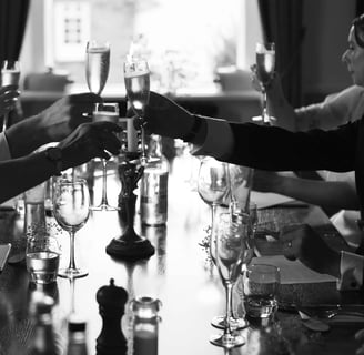 Classy black and white photo of wedding guests drinking champagne
