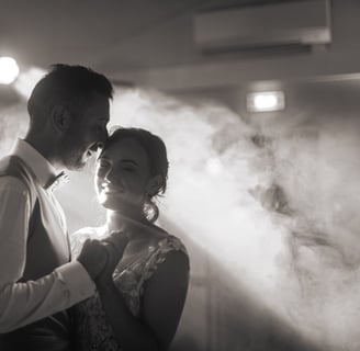 a man and woman standing in front of a smoke filled room