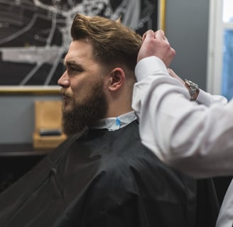 Hombre en una barbería cortándose el pelo