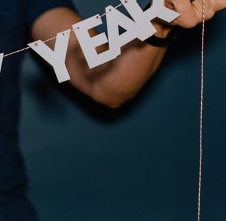 man holding a happy new year sign