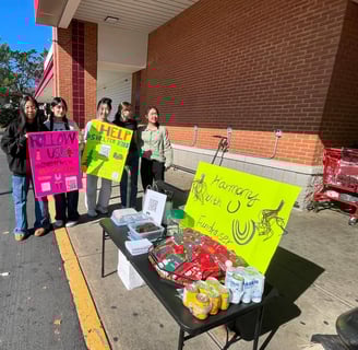 a group of people holding signs in front of a building