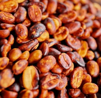 a pile of roasted beans on a wooden table