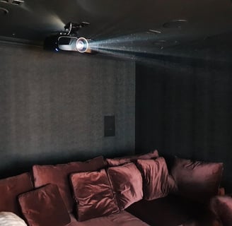 Epson projector mounted on a ceiling in a home cinema room