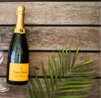 a bottle of champagne in front of a wooden table