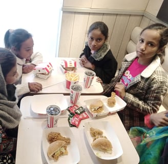 Sunday School children at Water of Life Ministries having lunch burgers and drinks