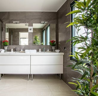 a bathroom with a large mirror and a shower