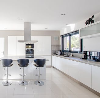 a kitchen with a bar stool and bar stools