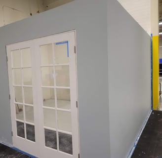 a room with a large white door and a blue wall