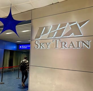 a sign that reads PHX Sky Train