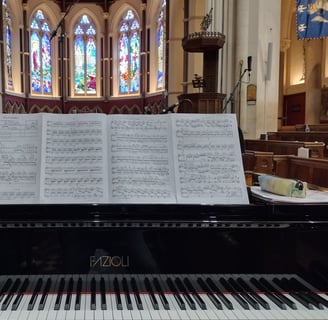 Photo of a grand piano in a chapel