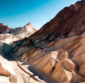 Death Valley, CA - Red Cathedral Mountains in the distance beyond Golden Canyon mountains