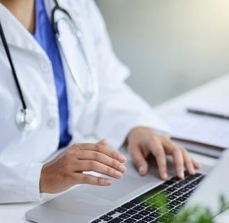 A doctor in front of her laptop