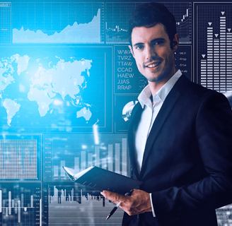 Business leader holds a notebook, while standing in front of a wall-sized screen displaying various charts and diagrams.