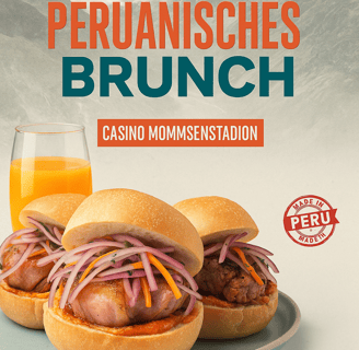 a plate with two sandwiches and a glass of orange juice