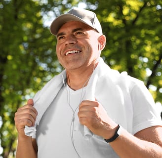 A middle-aged man smiling outdoors after a workout, emphasising fitness and metabolic health.