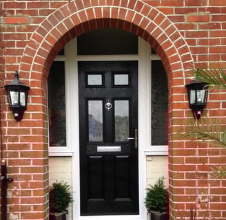 a black front door 2 panel 2 square glass with side panels
