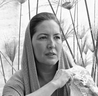 a woman in a shawl is holding a blanket