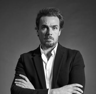 a man in a suit and tie is posing for a picture