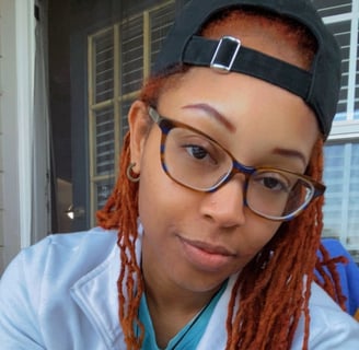 A woman with glasses smiling