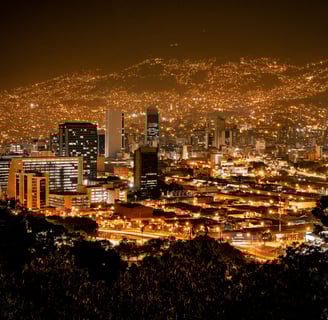 a cityscape of a city at night in Medellín, Colombia