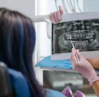 a woman in a dentist's office with a dentist's hand holding a