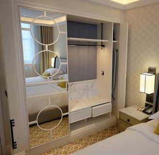 a bedroom with a bed and a mirror