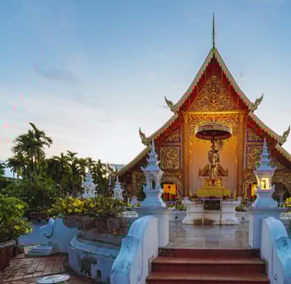 a small shrine with a statue of a woman in Chiang Mai, Thailand