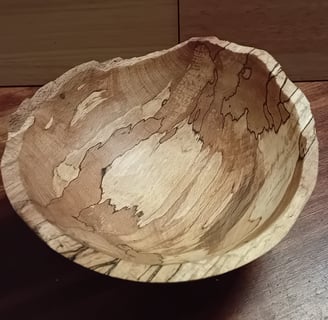 Turned spalted beech bowl with rough cleaved edge