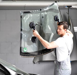 a man in a white shirt is standing in front of a car