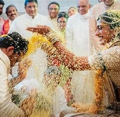 a man and woman in white wedding attire and a man in a white suit